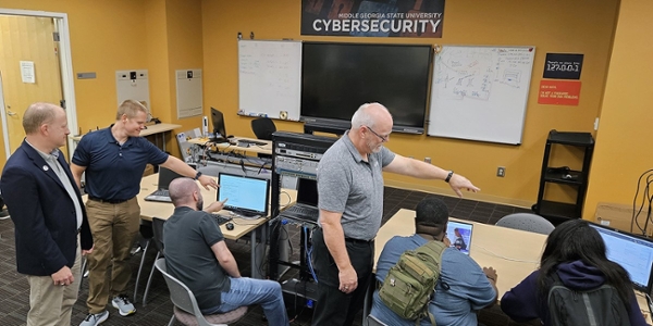 Students and faculty work in MGA's Cyber Forensics lab. 